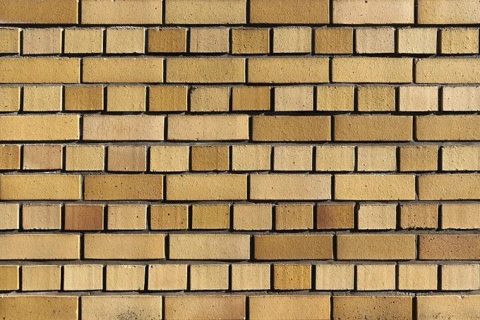 Impresión enmarcada : Pared hecha de ladrillos de clinker amarillo.