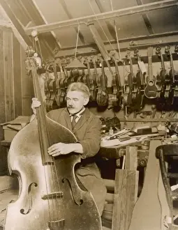 Stringed Instrument Maker Imprime: Stringed instrument maker in his workshop