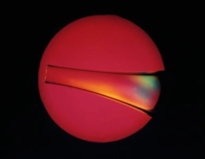 Polarised Light Micrograph Imprime: Defects in plastic, light micrograph