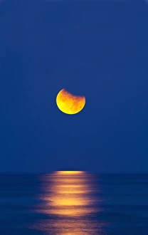 Partial Lunar Eclipse Imprime: Partially eclipsed setting moon