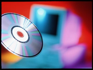 Digital Data Storage Solutions Imprime: View of CD-ROM disc in front of personal computer