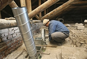 Construction Worker At Work Imprime: Worker installing ventilation