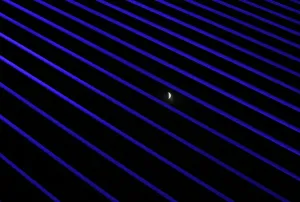 Total Lunar Eclipse Imprime: The moon is seen during the beginning of a total lunar eclipse through the structures of