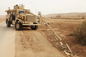 Middle East Military Operations Imprime: A MRAP vehicle disassembles an improvised explosive device