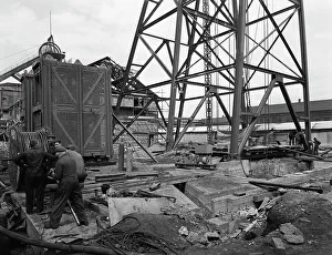 British Coal Industry Imprime: Installing a cage at Hickleton Main pit, Thurnscoe, South Yorkshire, 1961. Artist