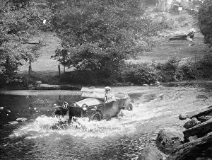 Black And White Car Images Imprime: A Lancia Lambda being driven through water, c1925