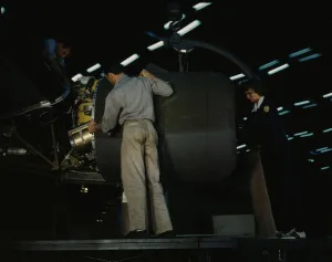 Aeronautical Engineer Imprime: Lowering an engine in place in assembling a C-87
