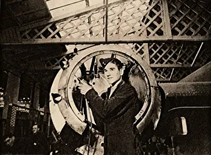 Metal Worker Imprime: A metal worker with automatic drill stripping an engine casing, 1940