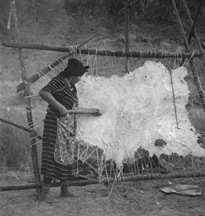 Female Artisan At Work Imprime: Method of scraping hide for softening