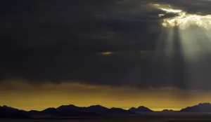 Desert Mountain Scenery Imprime: the sun breaks through the clouds in namibia, Namibia