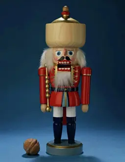 Christmas Celebration Decorations Imprime: Close-up of a nutcracker with a walnut beside it
