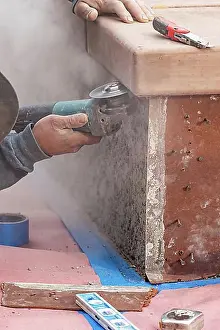 Construction Manpower Imprime: Construction worker using grinder at construction site