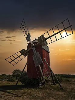 Dramatic Scandinavian Landscape Imprime: Backlit trestle windmill, dramatic evening sky