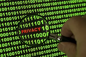 Data Protection Concept Imprime: Binary code with the word 'Privacy' viewed through a magnifying glass Binary code with the word