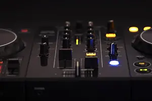 Professional Audio Equipment Imprime: A black DJ mixer with various buttons and knobs