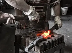 Handicraft Trade Imprime: Blacksmith and his assistant at work