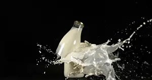 Black Background Photography Imprime: Bottle of Milk Exploding against Black Background