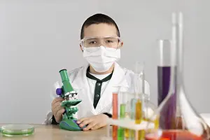 Laboratory Equipment Imprime: Boy laboratory with microscope