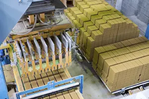 Factory Plant Equipment Imprime: Brickyard. Top view of machine and stacked bricks in workshop