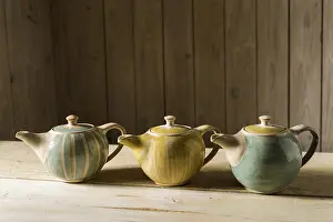 Handmade Ceramics Imprime: Ceramic workshop, three glazed pots on workbench