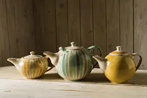 Handmade Ceramics Imprime: Ceramic workshop, three glazed pots on workbench