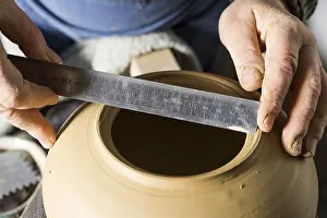 Traditional Crafts Bavaria Imprime: Ceramic workshop, hands measuring diameter of opening with ruler