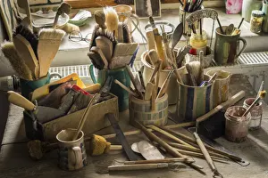 Ceramic Workshop Germany Imprime: Ceramic workshop, tools and brushes in pots on workbench