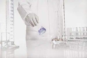 Chemist At Work Imprime: Chemist checking liquid in flask in a lab