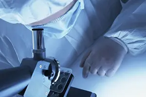 Microscope Examination Imprime: Chemist looking through a microscope