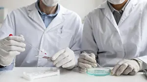 Teamwork In Healthcare Imprime: Close up scientists working together