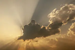 Deserted Landscape France Imprime: Cloud in front of the sun showing rays of light