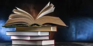 Open Book Imprime: A composition with an open book lying on a stack of other books