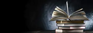 Stacked Literature Imprime: A composition with an open book lying on a stack of other books