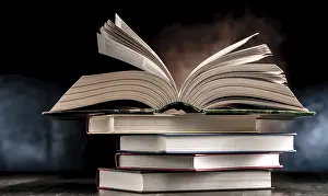 Educational Institution Imprime: A composition with an open book lying on a stack of other books