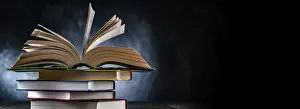 Educational Institution Imprime: A composition with an open book lying on a stack of other books