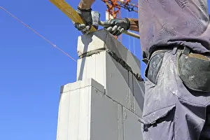 Residential Building Construction Imprime: Construction worker (bricklayer) on the building site