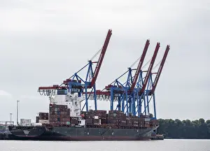 Northern Germany Logistics Imprime: Container ship, loading cranes and stacks of containers