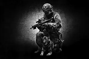 German Shepherd Breed Imprime: Dog handler posing in the studio with a trained shepherd