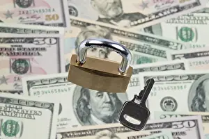 US Dollar Notes Imprime: Many dollar banknotes with a lock
