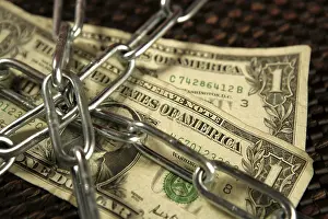 Brown Background Studio Shot Imprime: One Dollar notes in chains studio shot over brown background