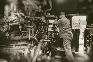 Deserted Railway Station Imprime: Engine driver working on steam train engine