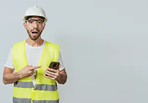 Construction Engineer Imprime: Engineer using and pointing at cellphone