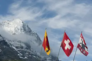 Swiss National Flag Imprime: Flags in front of the snow-covered Eiger Mountain