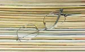 Magazine Stack Imprime: Glasses on the background of the stack of magazines