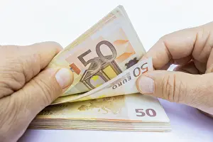 Payment Transaction Imprime: Two hands counting stack of 50 euro notes