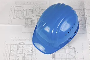 Deserted Construction Site Europe Imprime: Hard hat lying on a construction plan