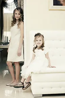 Sisterly Love Images Imprime: Image of elegant sisters posing looking at camera