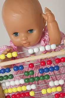 Educational Institution Image Imprime: Learning arithmetics, doll using an abacus
