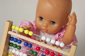 Educational Institution Concept Imprime: Learning arithmetics, doll using an abacus