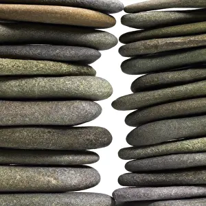 Deserted Beach Landscape Imprime: Low angle view of two flat pebble stone stacks in light back